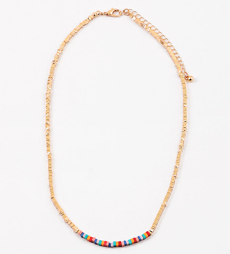 Dainty gold bead necklace with small red, yellow and turquoise beads at its center.