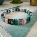 Picture of a bead bracelet in teals, pinks, browns and clear beads.
