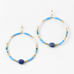 Pair of hoop earrings with blue, gold, and white beads on a white background