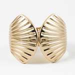 Gold shell-shaped cuff bracelets on a white background