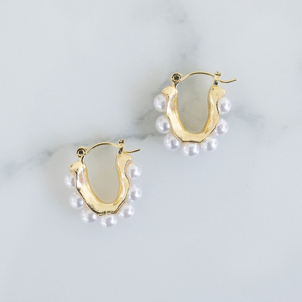 Picture of small U-shaped gold earrings with pearls