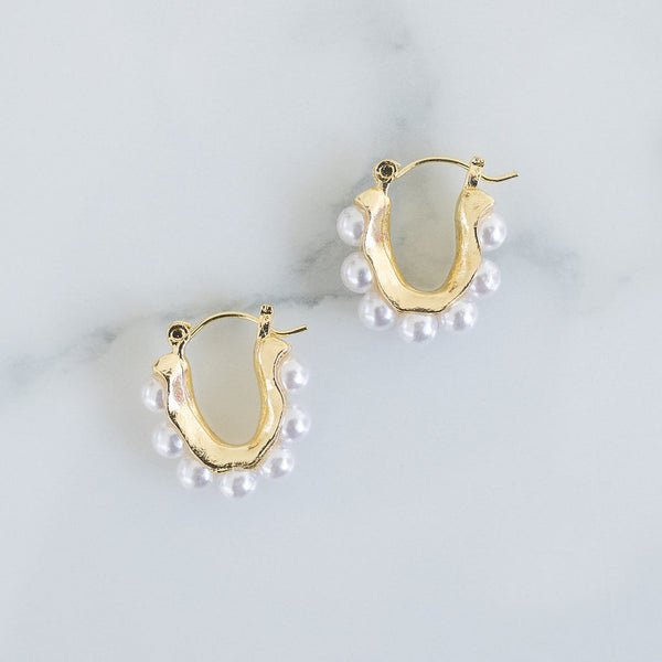 Picture of small U-shaped gold earrings with pearls