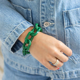 Woman wearing a thick green link chain resin bracelet