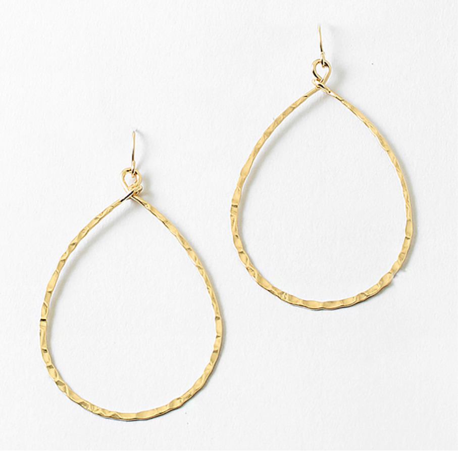 Gold tear drop dangle hoop earrings on a white background