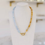 Light blue and amber beaded necklace with a gold clasp.
