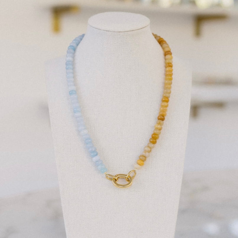 Light blue and amber beaded necklace with a gold clasp.