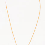 A gold-colored necklace with two interlocking circles as the central pendant on a white background.