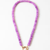 Purple beaded necklace with a gold clasp on a white background