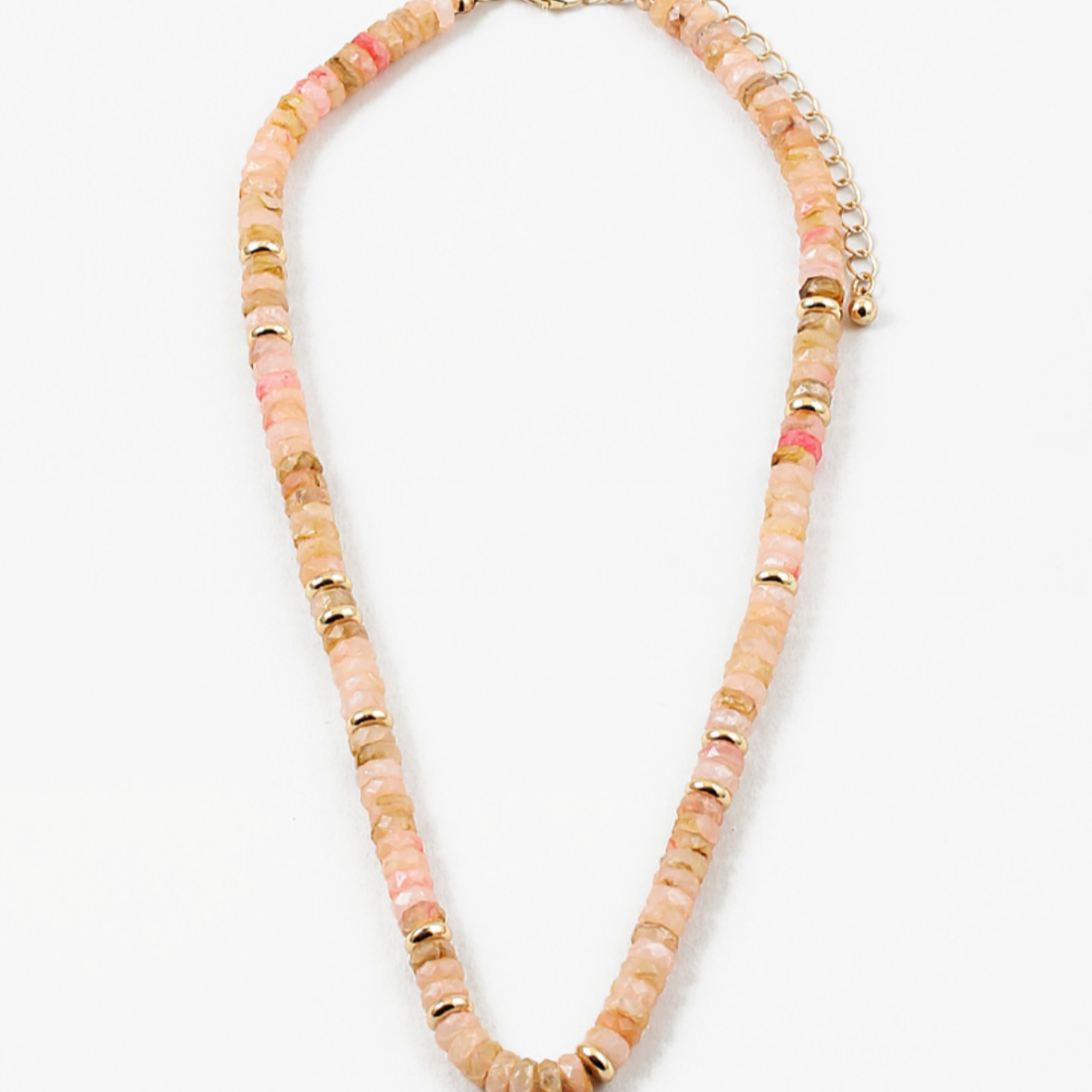 Picture of peach colored bead necklace with gold spacers beads interspersed through out.