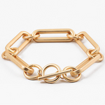 Picture of a large gold linked bracelet with a toggle clasp.