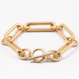Picture of a large gold linked bracelet with a toggle clasp.