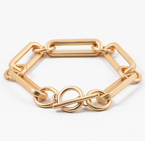 Picture of a large gold linked bracelet with a toggle clasp.
