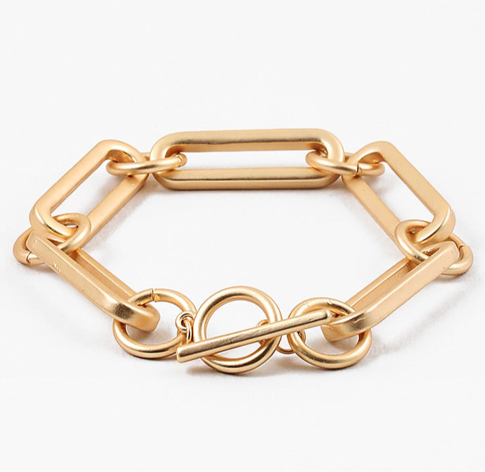 Picture of a large gold linked bracelet with a toggle clasp.