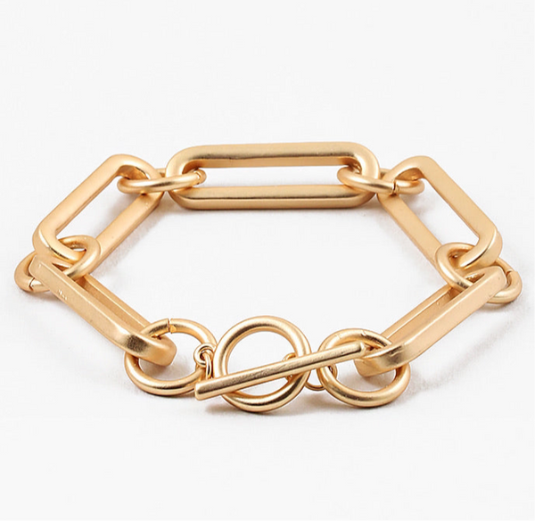 Picture of a large gold linked bracelet with a toggle clasp.