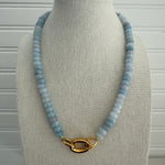 Light blue beaded semi-precious stone necklace with large gold clasp.
