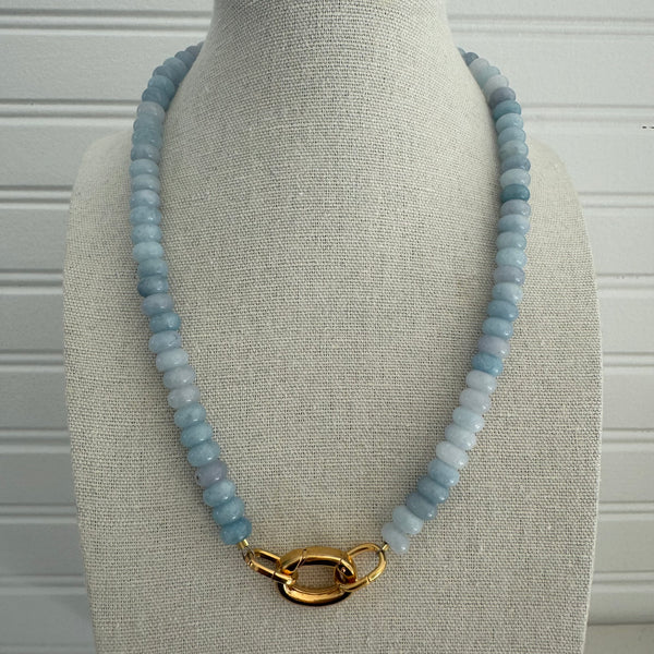 Light blue beaded semi-precious stone necklace with large gold clasp.