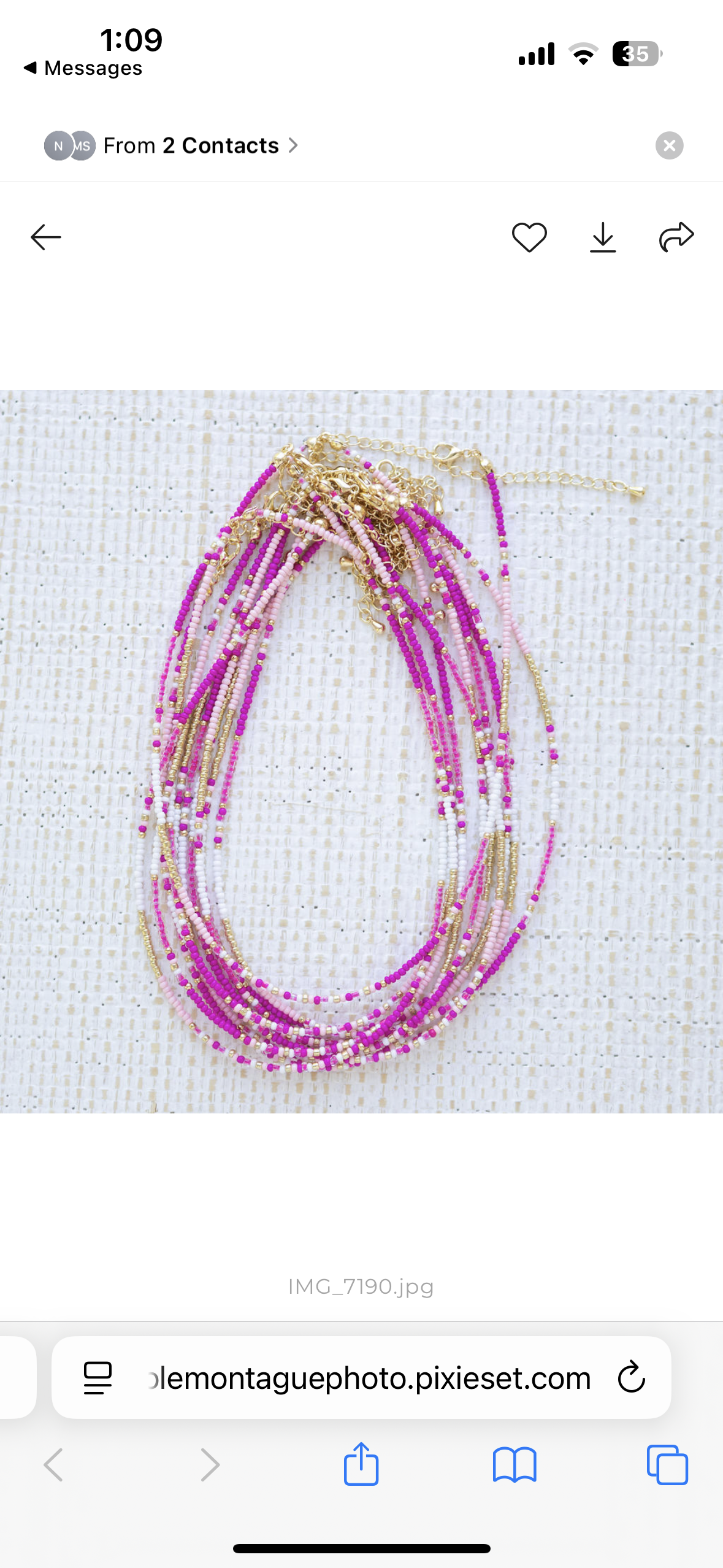 Screen shot of a stack of necklaces with pink and gold beads on a white background