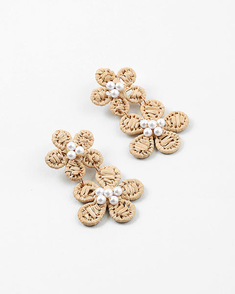 Flower dangle earrings. Earrings are made of tan woven material with small seed pearls as their center. There are two flowers on each earring.