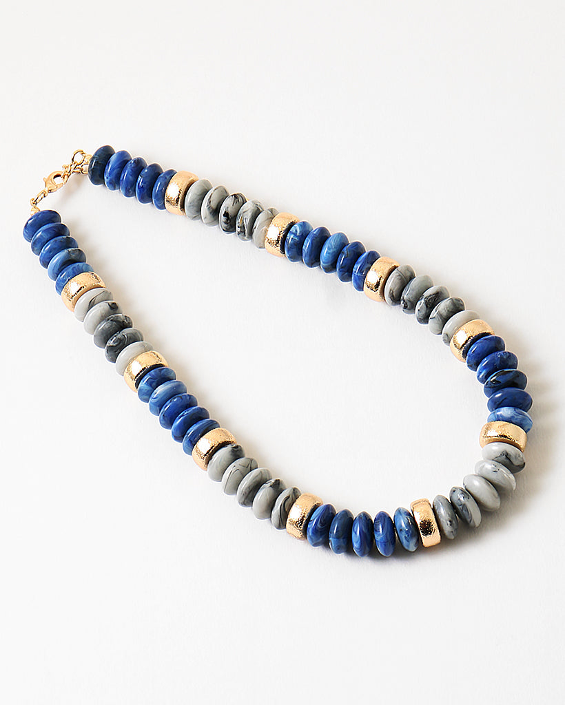 Chunky necklace with blue, gray and gold beads.