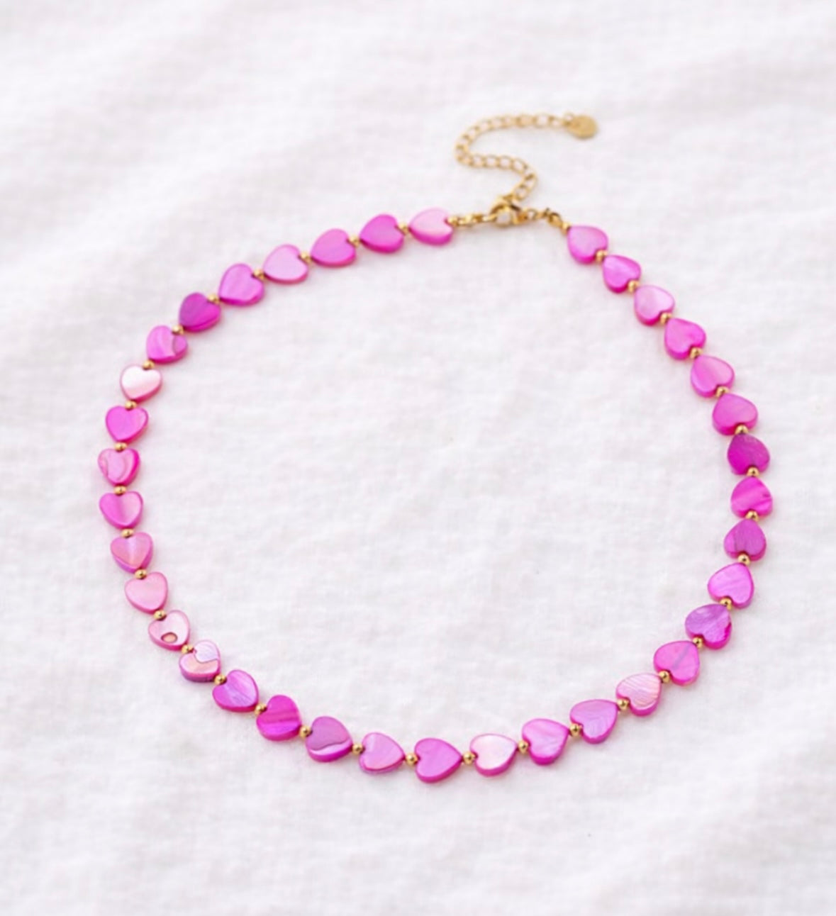 Necklace with pink heart-shaped beads on a white background