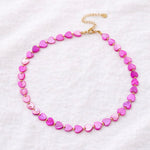 Necklace with pink heart-shaped beads on a white background