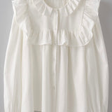 Picture of a white long sleeved dress shirt. Shirt has a ruffle around the collar and the breast and cuff sleeves. Shirt buttons down the front.