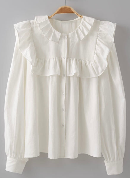 Picture of a white long sleeved dress shirt. Shirt has a ruffle around the collar and the breast and cuff sleeves. Shirt buttons down the front.