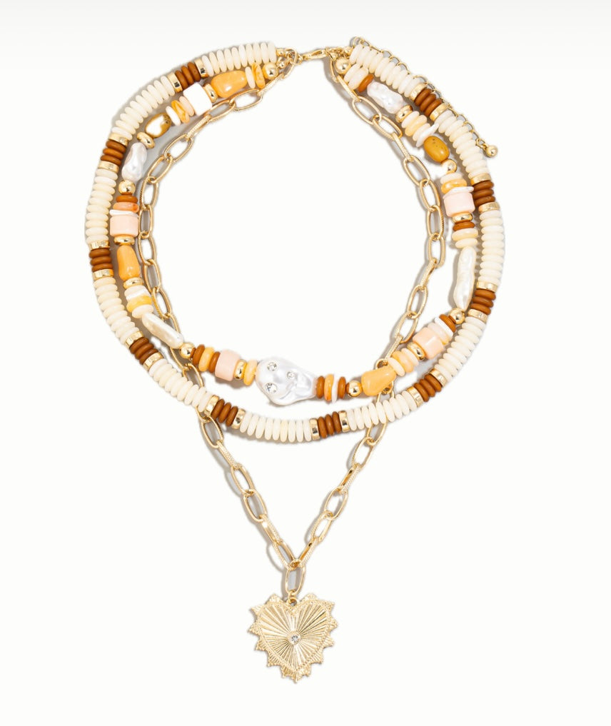 Set of layered necklaces with beaded and chain designs on a white background
