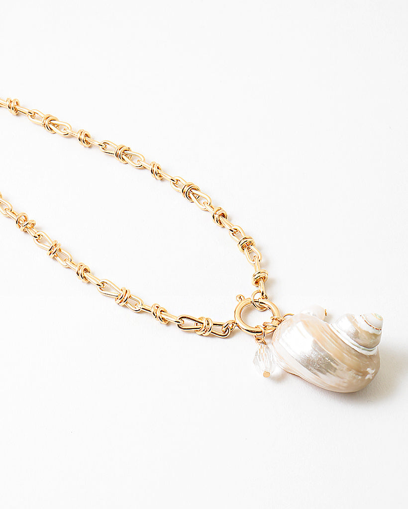 Large linked gold chain with a toggle clasp and a large pearlescent shell pendant.