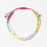 Bracelet made of double strands of beads in pinks, teals, whites and yellows.