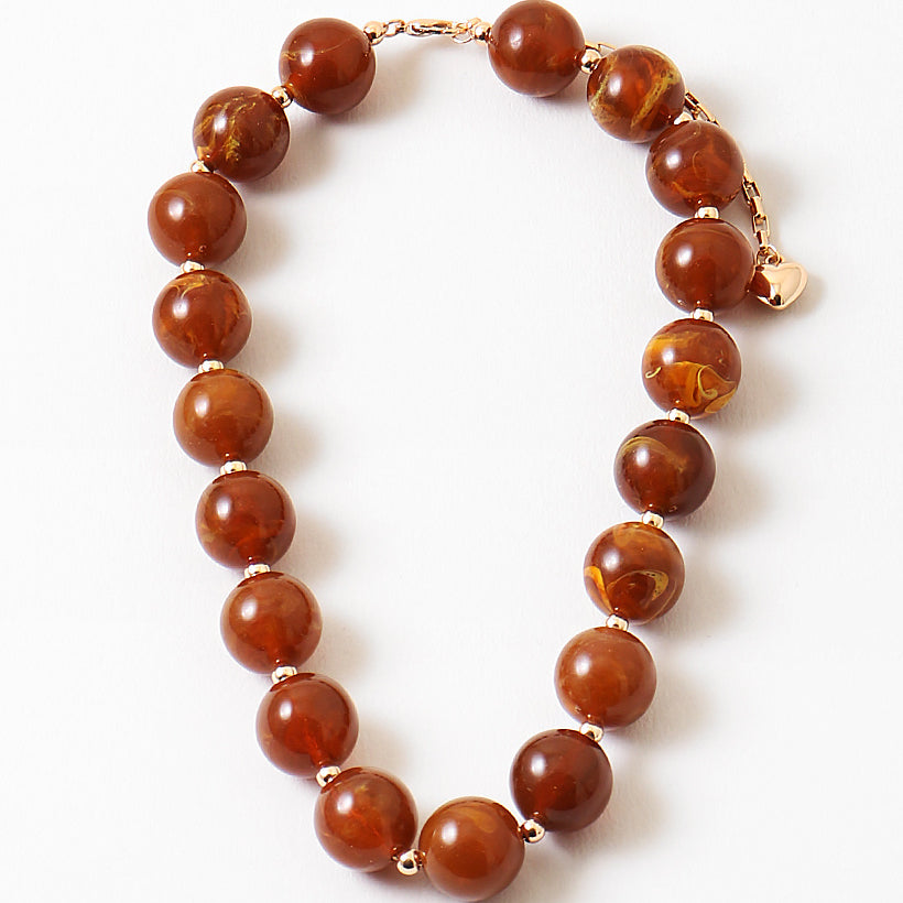 Chunky rust orange bead necklace.