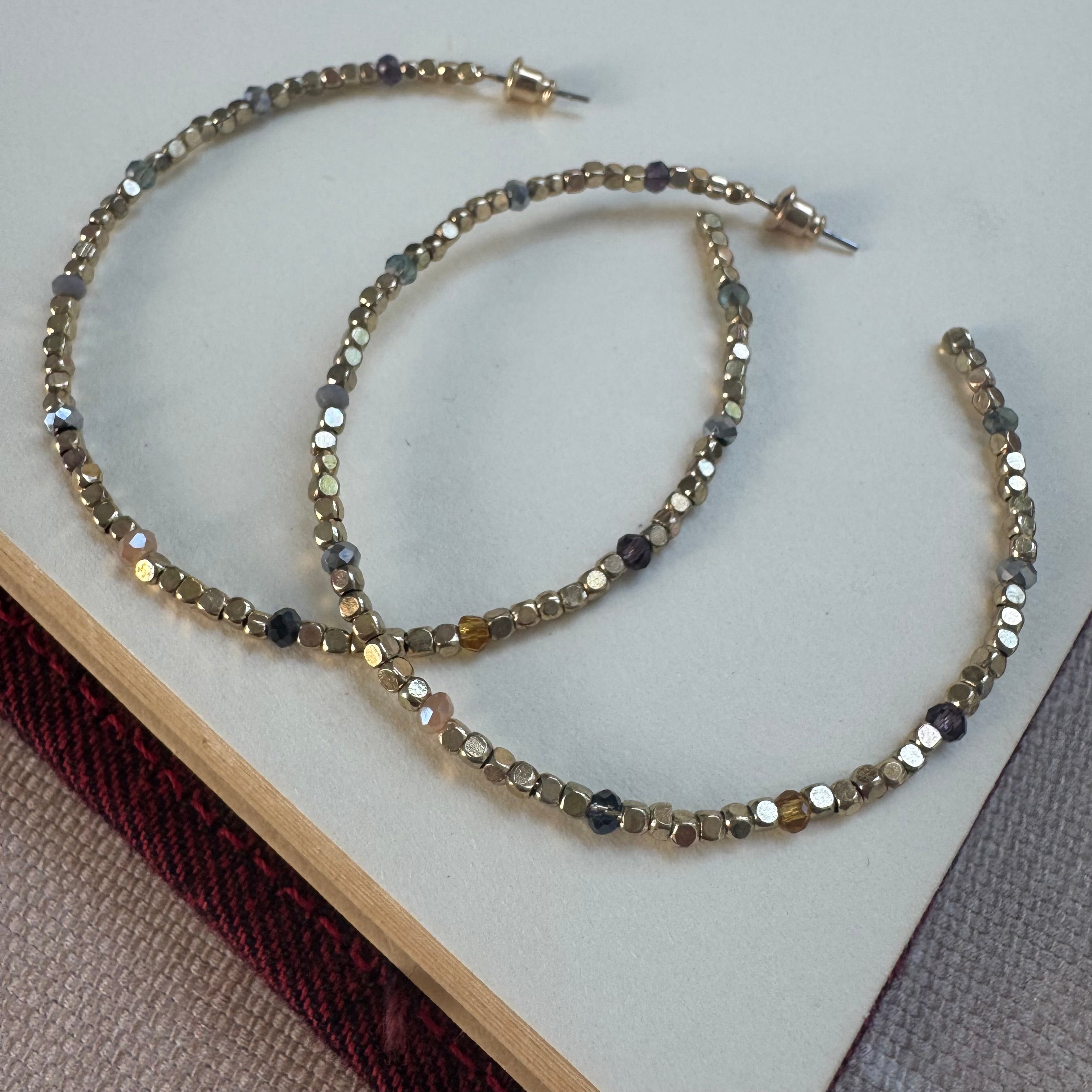Large gold bead hoop earrings.
