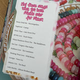 Magazine page of colorful beads on a decorative plate with a paper card featuring playlist text.
