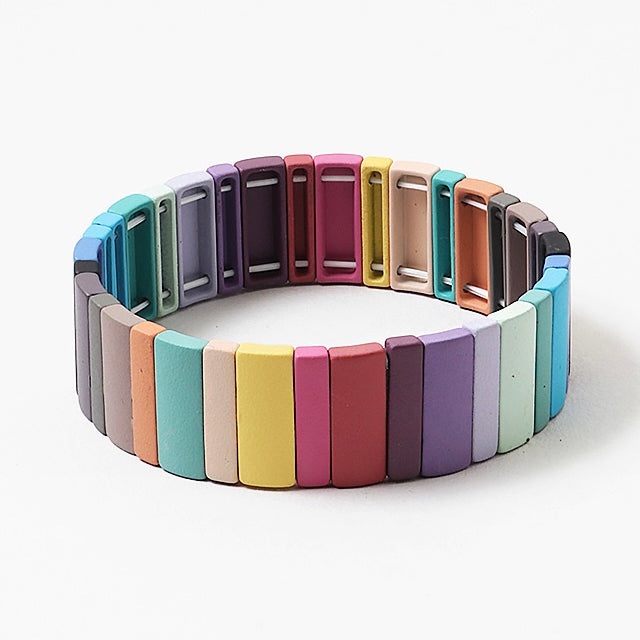 Multicolored bracelet with rectangle beads in muted colors on a white background