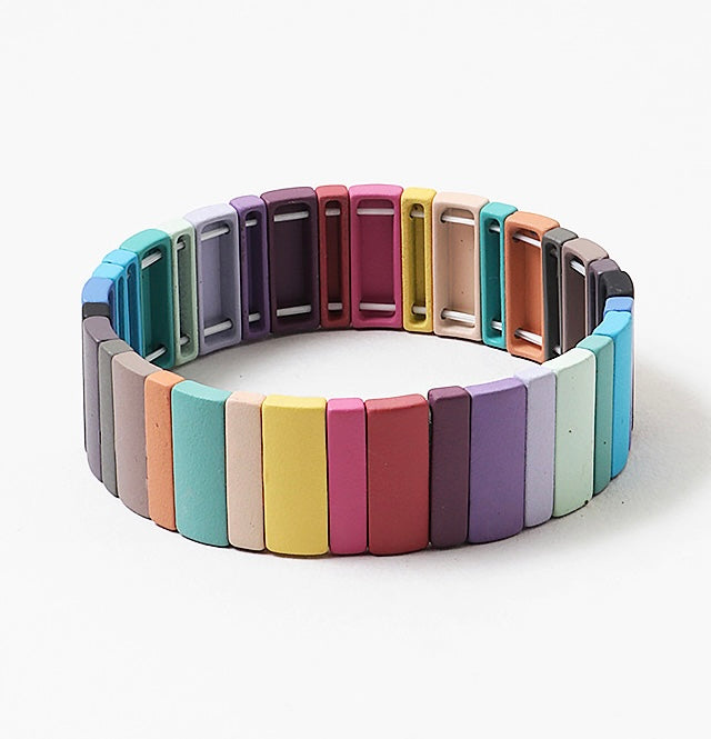 Multicolored bracelet with rectangle beads in muted colors on a white background