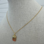 Picture of a dainty gold chain and a gold 11:11 charm