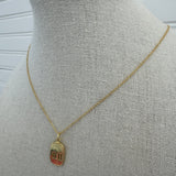 Picture of a dainty gold chain and a gold 11:11 charm