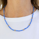 Blue beaded necklace with gold spacer beads