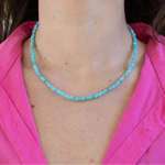Graphic of woman's neck wearing a blue bead necklace.