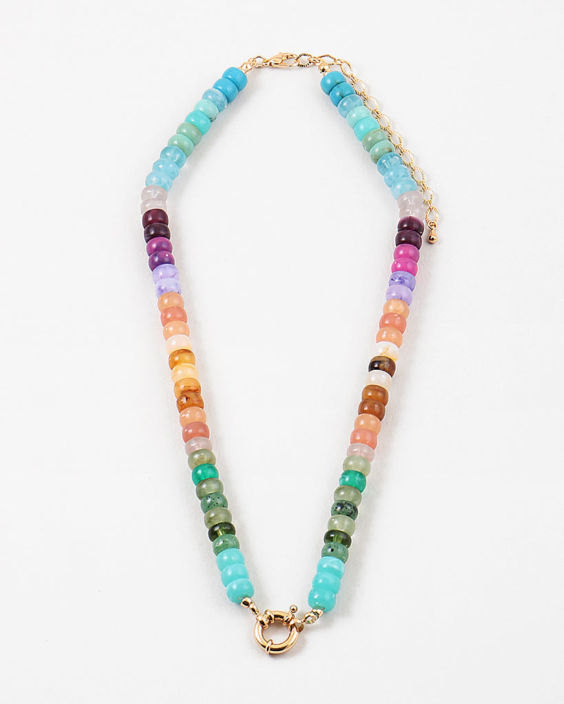 Picture of a bead necklace in blues, purples, oranges and greens with a gold toggle clasp.