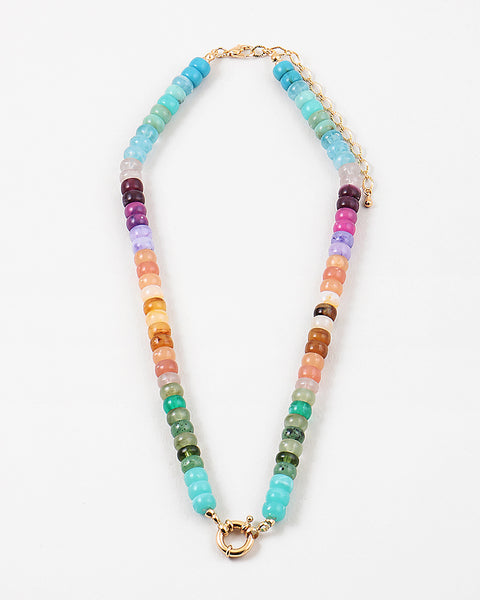 Picture of a bead necklace in blues, purples, oranges and greens with a gold toggle clasp.