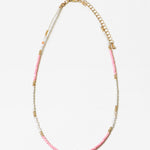 Necklace with pink, whitewith a central pink stone on a white background