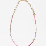 Necklace with pink, whitewith a central pink stone on a white background