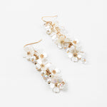 Picture of dangle earrings with white stacked dogwood flowers