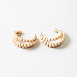 Triple hoops threaded through small wooden beads.