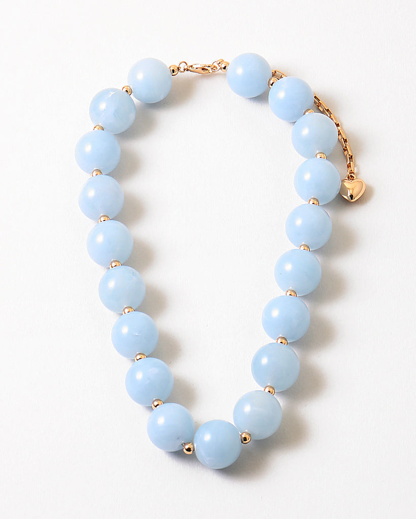 Bracelet with large light blue beads.