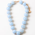 Bracelet with large light blue beads.