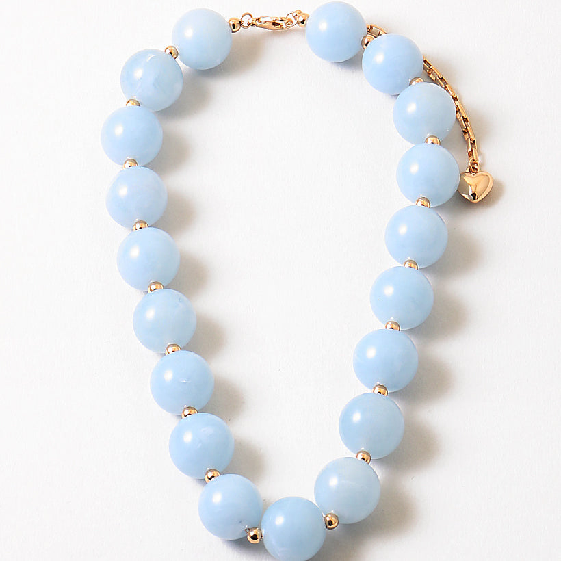Bracelet with large light blue beads.