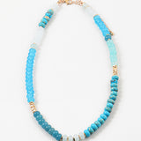 Picture of a blue and white beaded necklace with gold accent beads.