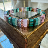Picture of a bead bracelet in teals, pinks and clear browns